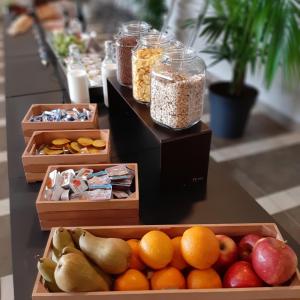 three boxes of food on a table with fruits and nuts at Fabulous village in Casal Palocco