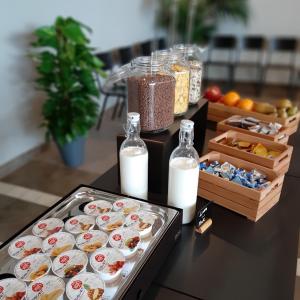 a table topped with plates of food and bottles of milk at Fabulous village in Casal Palocco