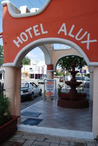 an entrance to a hotel alula sign in a parking lot at Hotel Alux Cancun in Cancún
