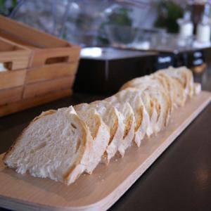 a long loaf of bread on a cutting board at Fabulous village in Casal Palocco
