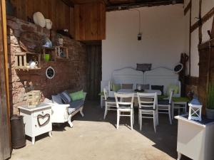 un patio con mesa, sillas y sofá en Ferienhaus Nr. 10 en Buergstadt