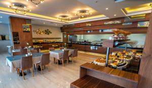 a dining room with tables and chairs in a restaurant at Campus Hill Hotel in Alanya