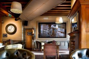 a living room with a large flat screen tv at Dinn R&iacute; Hotel in Carlow