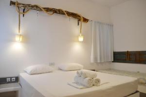 a bedroom with two towels on a bed at Paleochori Studios in Paliochori