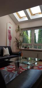 a living room with a couch and a glass table at Apartment Serene Retreat in Regensburg