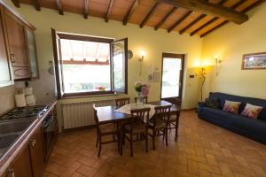 kuchnia i salon ze stołem i krzesłami w obiekcie Agriturismo Casale del Contadino w mieście Bolsena