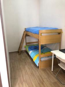 two bunk beds in a small room with a wooden floor at La Casa Di Fafa in Naples