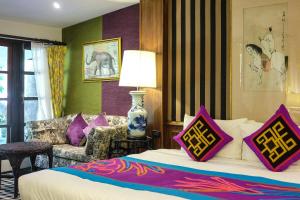 a hotel room with a bed and a couch at Zantiis Ndol Villas in Muak Lek District