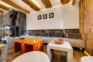 a room with a table, chairs and a fireplace at Chalet Hotel Du Fornet in Val-d'Isère