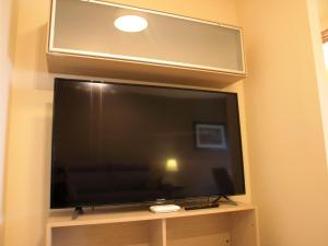 a flat screen tv sitting on a stand in a room at Tarragona Ciudad, El Serrallo AP-2 in Tarragona