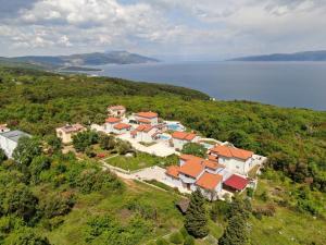 an aerial view of a house on a hill next to the water at VILLA MARINE YourCroatiaHoliday in Drenje