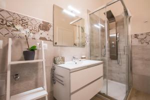 a bathroom with a sink and a shower at La Dotta Apartments in Bologna +76 photos