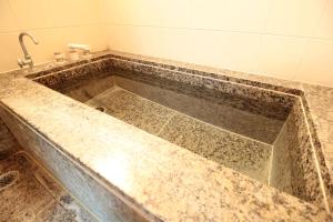 a bathtub in a bathroom with a sink at Hakone Yumoto Condominium Sakura with Hot Spring B-9 #Hs1 in Hakone +42 photos