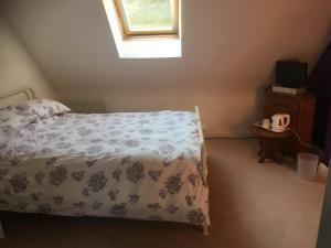 a small bedroom with a bed and a window at Moorclose Bed and Breakfast in St Bees