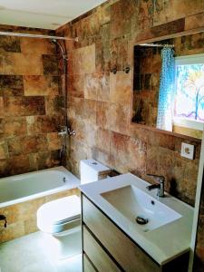 ein Badezimmer mit einem Waschbecken, einem WC und einem Spiegel in der Unterkunft Apartamento entero "El Casco Antiguo" in Xàtiva