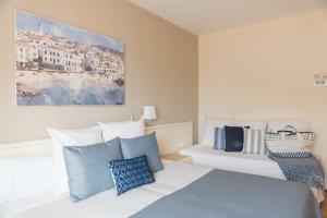 a bedroom with a bed with blue and white pillows at Hotel Terramar in Llafranc