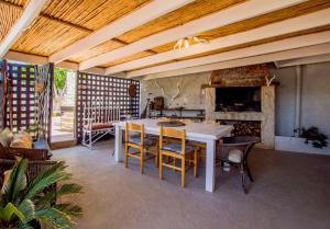 a dining room with a white table and chairs at Ladera - Vista Self-catering Guesthouse in Paarl