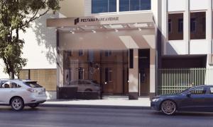 two cars parked in front of a building at Pestana Park Avenue in New York