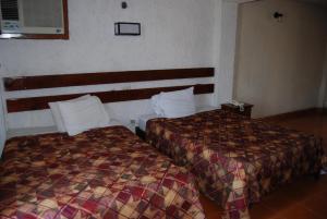 Postel nebo postele na pokoji v ubytování Hotel Tankah Cancun