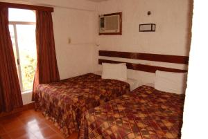 Postel nebo postele na pokoji v ubytování Hotel Tankah Cancun