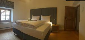 a bedroom with a large bed with a candle on it at Apartment Der Riese in Reith bei Seefeld