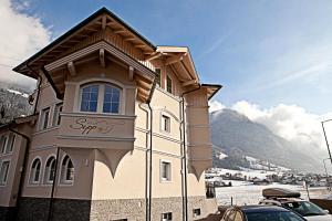 a building with a sign on the side of it at Villa Sepp in Ramsau im Zillertal