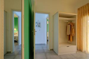 a walk in closet with a green wall at The Village Apartments in Plakias