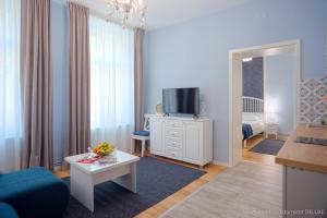 a living room with a couch and a tv in it at Republicii Residence in Braşov