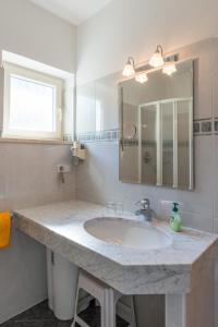 a bathroom with a sink and a mirror at Apartments Villa Majense in Merano +73 photos