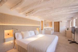 a bedroom with a large white bed in a room at Can Simoneta - Adults Only in Canyamel +120 photos