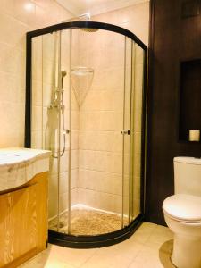 a shower with a glass door in a bathroom at Xi'an Hantang House in Xi'an
