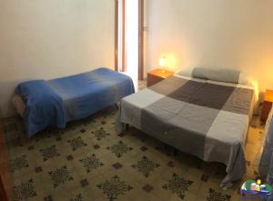 a bedroom with two beds and a window at Magi - Ulivo in Ponza