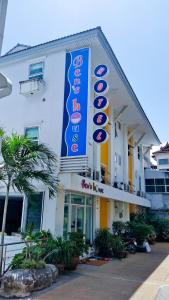 a white building with a blue sign on it at Ben's House in Ao Nang Beach