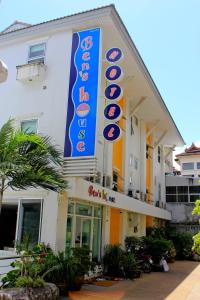 a hotel with a large sign on the side of it at Ben's House in Ao Nang Beach