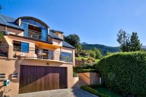 a house with a fence and a garage at Amazing View Home in Queenstown