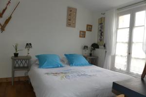 A bed or beds in a room at La Passerose jardin clos 300mplage la Couarde sur mer