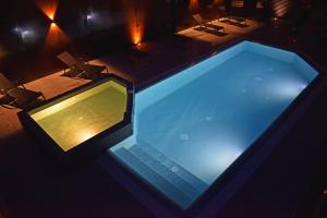 an overhead view of a swimming pool at night at Residence Lake Como in Colico