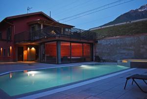 a swimming pool in front of a house at Residence Lake Como in Colico