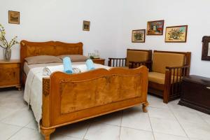 Un dormitorio con una gran cama de madera con almohadas azules en Seaside Villa Halkidiki, en Nea Iraklia