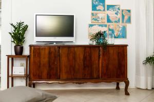 un televisor sentado en la parte superior de un centro de entretenimiento de madera en Seaside Villa Halkidiki, en Nea Iraklia