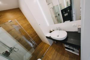 a bathroom with a sink and a shower at Hypnotize Apartment in Konin