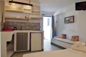 a small kitchen with a couch in a room at Paleochori Studios in Paliochori