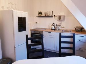 a kitchen with a white refrigerator and a sink at 25mn to HH-2BR Kitchen&Netflix in Elmshorn