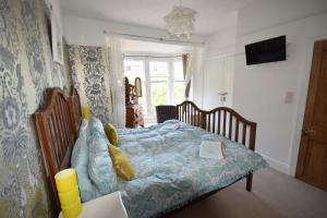 a bedroom with a bed with a blue comforter at Newberry Beach lodge in Combe Martin
