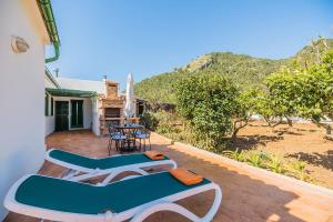 a balcony of a house with a table and chairs at Can Boi in Pollença