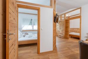 a room with a bed and a sliding door at Sport & Familienhotel Bärenwirt in Aich
