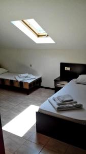 a bedroom with two beds and a skylight at Hotel Acropolis Palace in Kabardinka