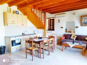 a kitchen and living room with a table and a couch at Villa Chrysodimi in Halki