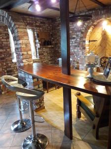 a large wooden table in a room with a brick wall at Ausekla Street Holiday Home in Liepāja