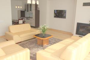 a living room with two couches and a coffee table at Family friendly Apartment Baltic Seaside in Šventoji